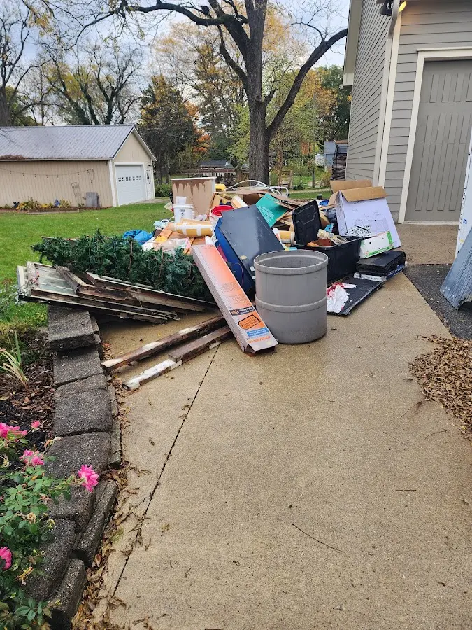 Dumpster being loaded with debris for Estate Cleanout Dumpster Rental in Wall